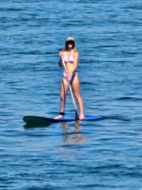 Paddleboarding in calm coastal waters off Denpasar, Bali