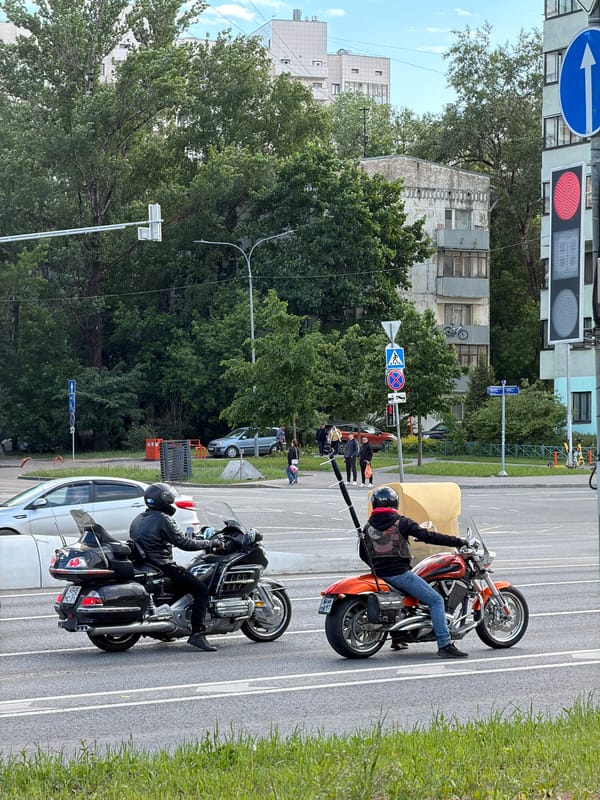 Motorcycles parked on Moscow street with rider and pedestrians