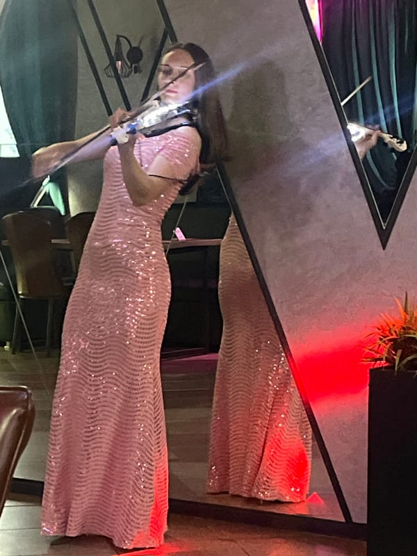 Live violin, group photos, and a meal at an Orsha event