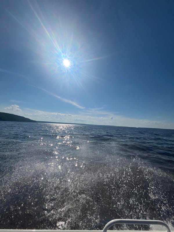 Sunny boat ride across open water near Siukterka, Russia