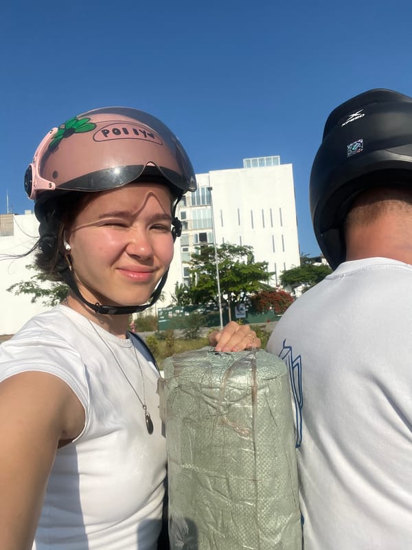 Moped riders transport wrapped cargo in Nha Trang