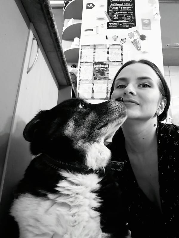 Woman and dog share affectionate moment in Rusalevka home