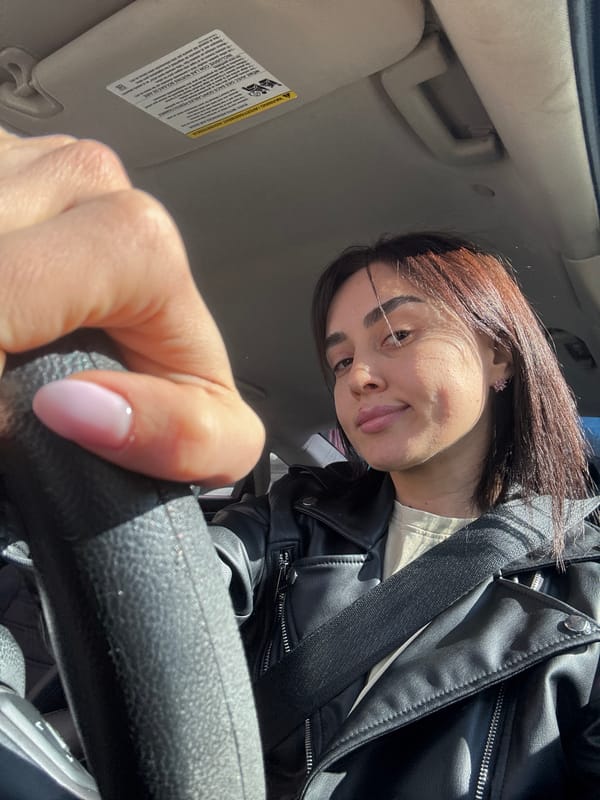 Woman takes car selfies in Tbilisi at dawn