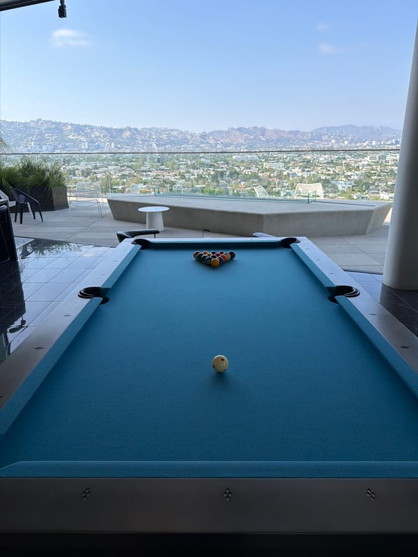 Pool table set up on Los Angeles balcony overlooks city