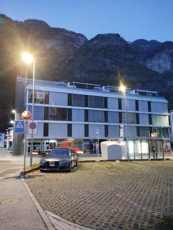 Evening twilight walk documented through Biasca, Switzerland town center