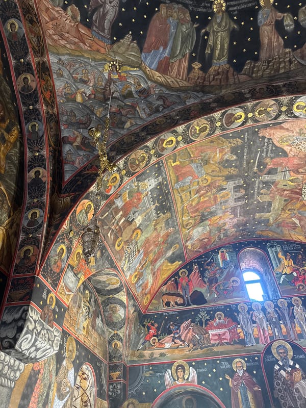 Visitor documents ornate frescoes at Bulgaria's historic Bachkovo Monastery
