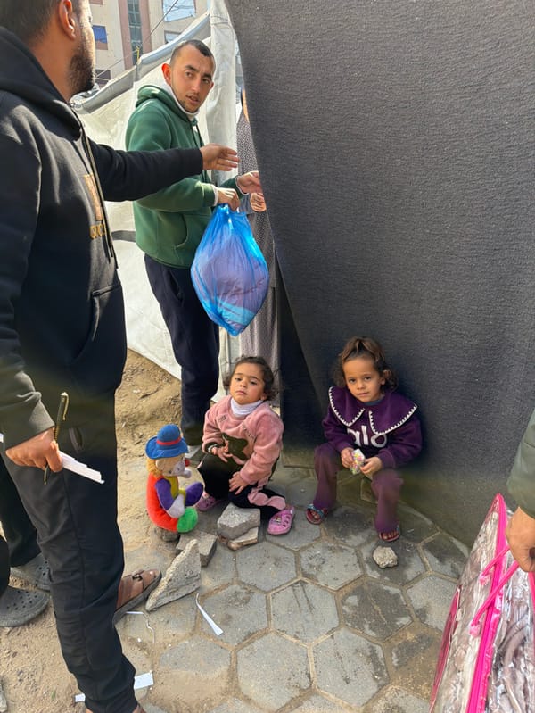 Aid workers distribute supplies to Gaza families in tent settlements