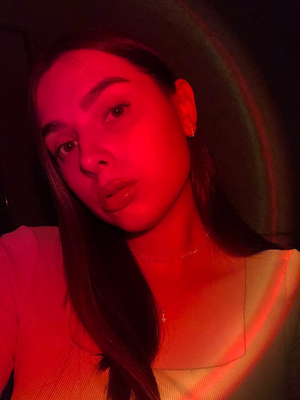 Colorful selfie portraits shot under dramatic red lighting in Russia