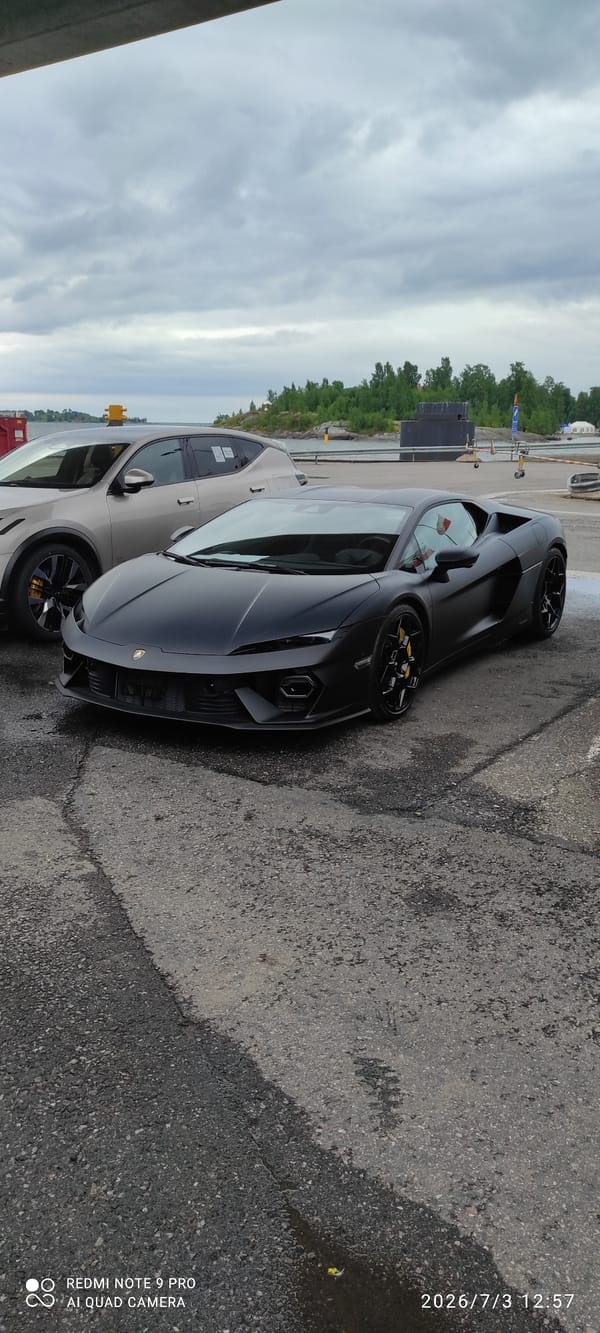Matte black Lamborghini parked waterside in Helsinki