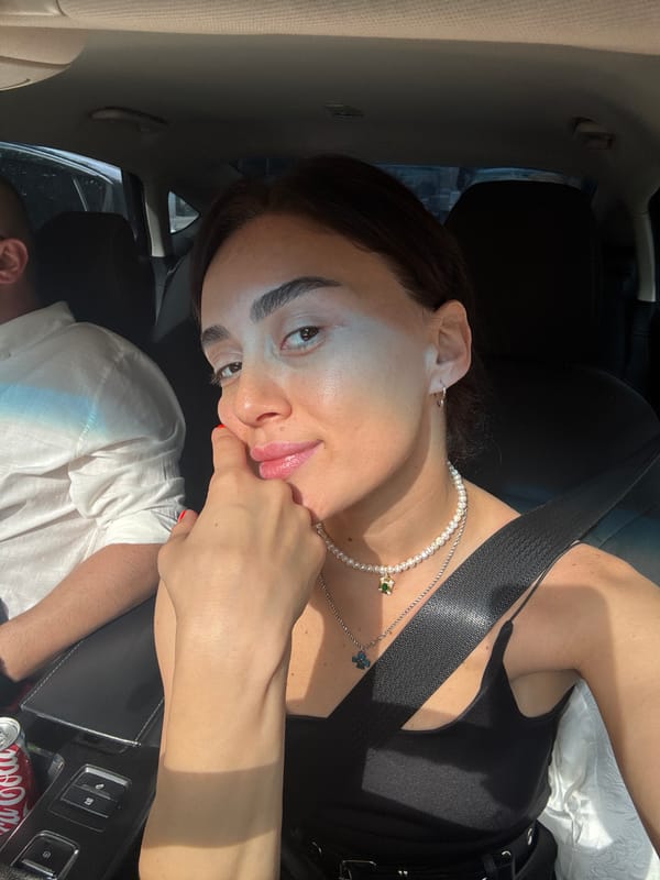 Woman takes selfies during early morning car ride through Tbilisi