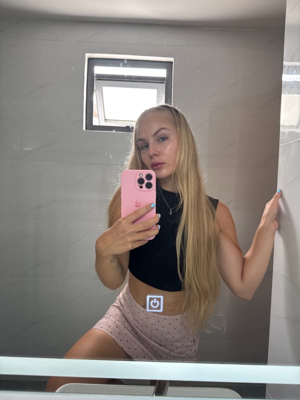 Mirror selfies in a Nha Trang hotel room, pink skirt outfit