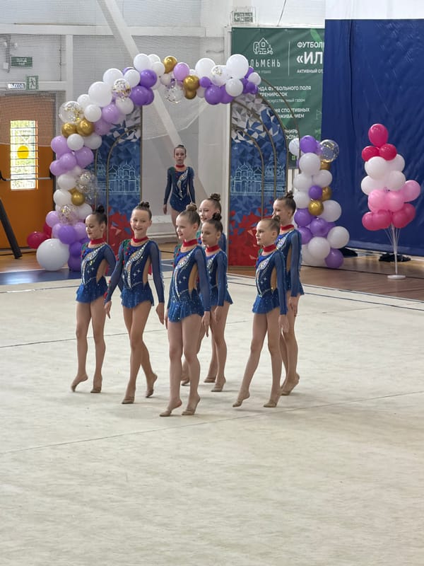 Young gymnasts and cheerleaders perform routines in Veliky Novgorod gymnasium