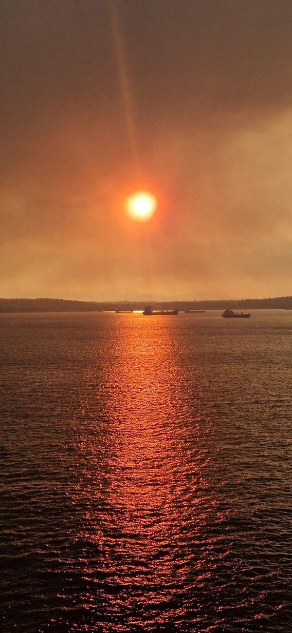 Superyacht cruises Gulf of Corinth at hazy sunset