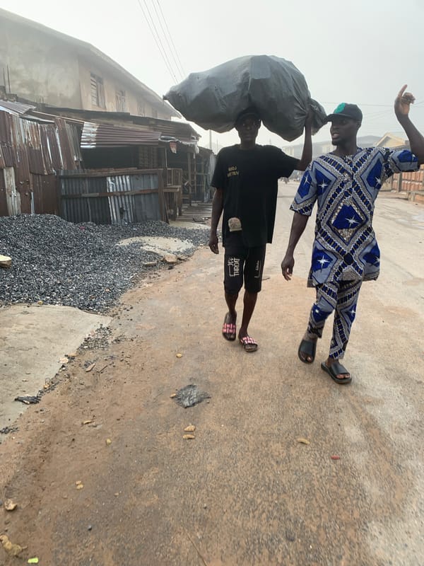 Morning street life in Shagamu, Nigeria — people moving, motorcycles rolling