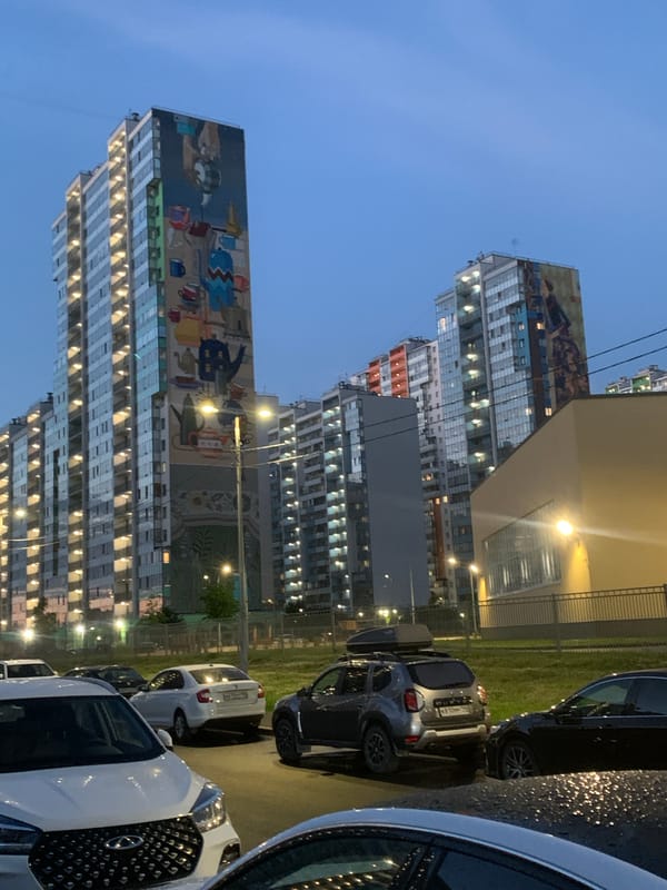 Giant murals cover apartment blocks in Saint Petersburg at dusk