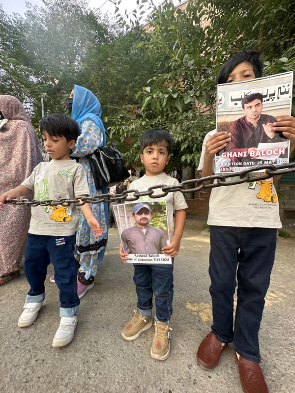 Families protest in Quetta holding photos of missing persons