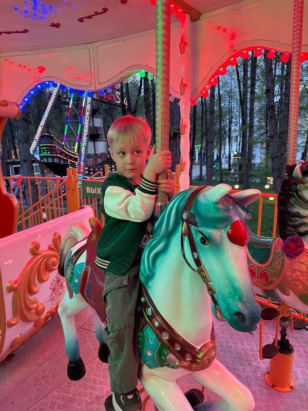Child enjoys carnival rides at Perm entertainment venue