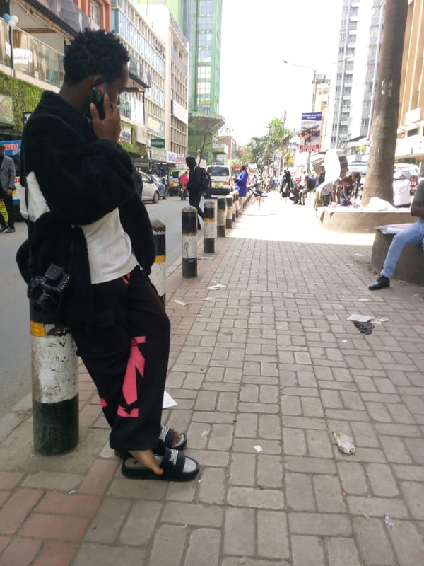 Man makes phone call on Nairobi sidewalk