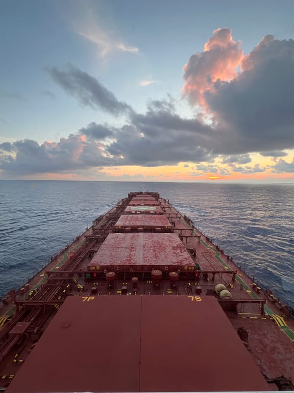 Cargo ship crosses the South China Sea at sunset