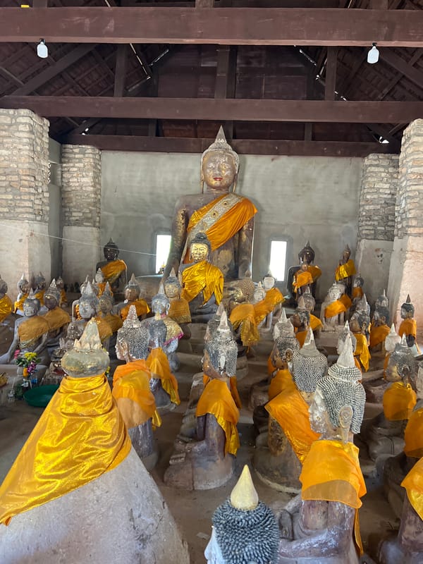 Visitors document Buddha statues at Baan Harn temple, Thailand