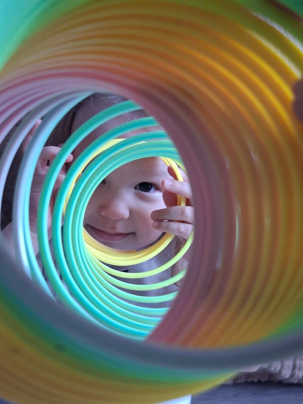 Children play with toys on colorful mats during morning playtime