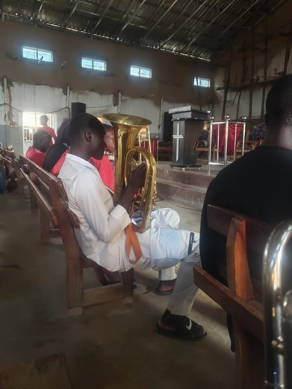 Indoor gathering with tuba player in community space