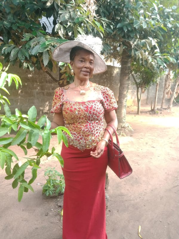 Woman in formal red attire observed in Umuode, Nigeria