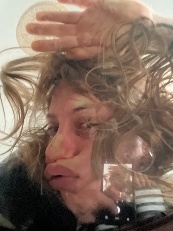 Person observed looking at glass surface in Vicente López