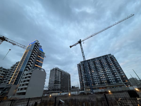 Construction cranes tower over modern buildings in Sofia