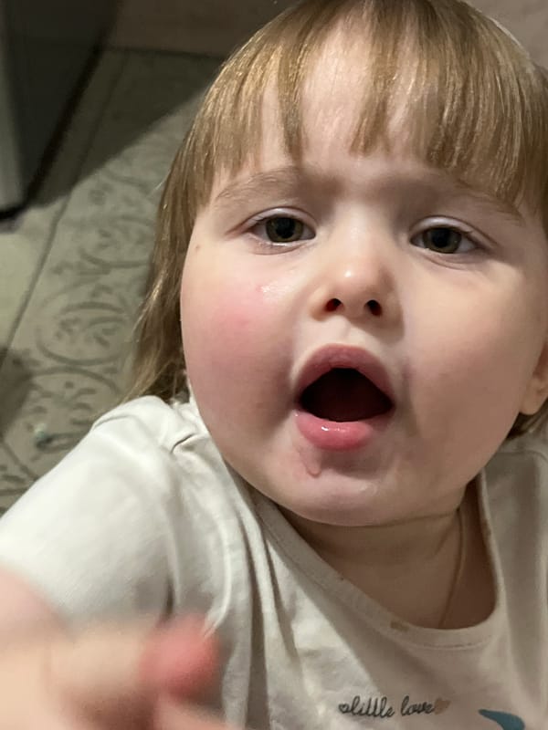 Children captured in casual indoor moments at same location