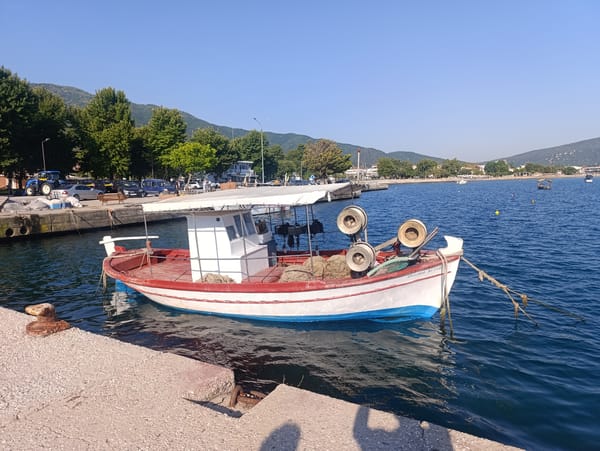 Boats moored at a quiet harbor in Stavros, Greece