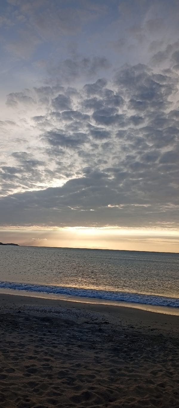 Tourists capture sunset moments along Juan Griego's Caribbean coast