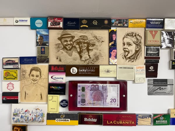 Matchbox and memorabilia collection displayed on wall in Bulgaria