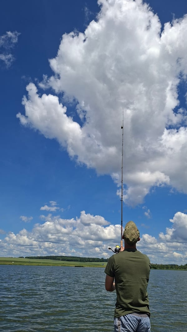 Lazy summer fishing day at a Smalyavichy lakeside