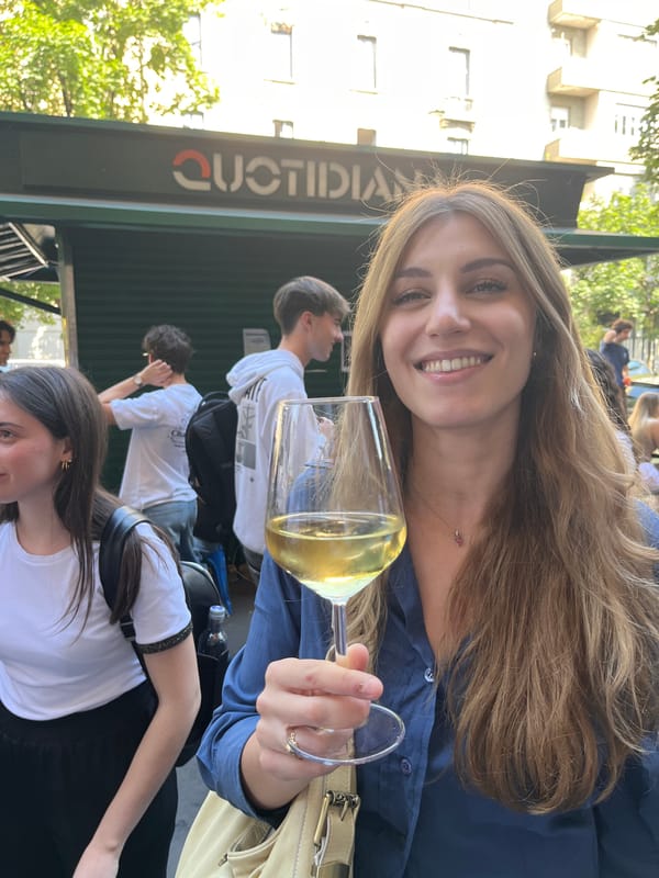 Woman enjoys white wine in Milan afternoon