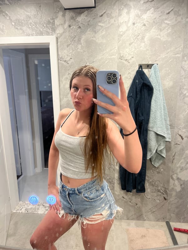 Indoor mirror selfie, casual outfit with silver cross necklace