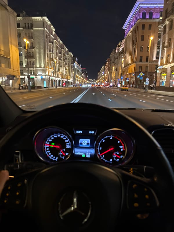 Night drive through a lit-up urban boulevard