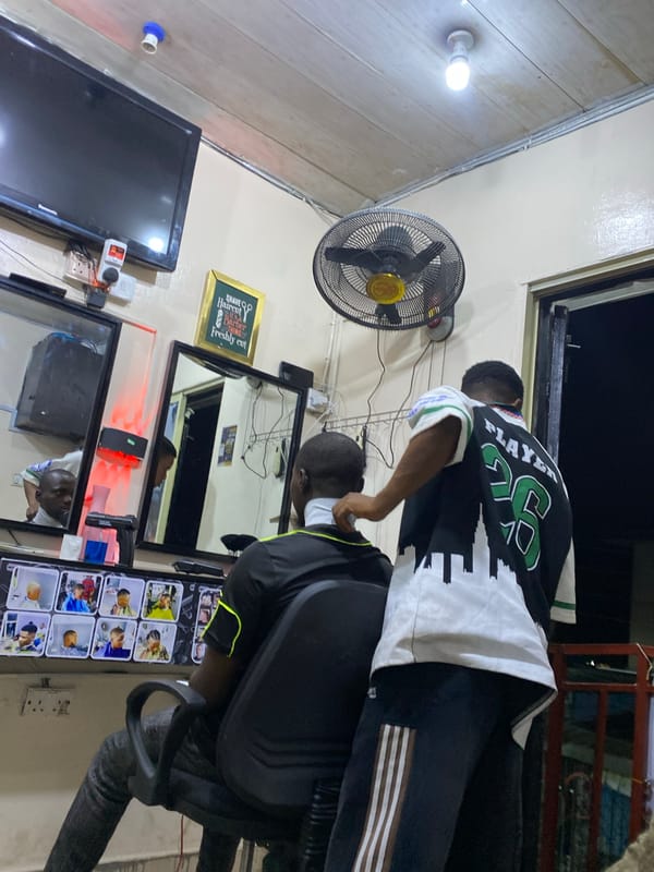 Evening haircut session documented at Ado Nigeria barbershop
