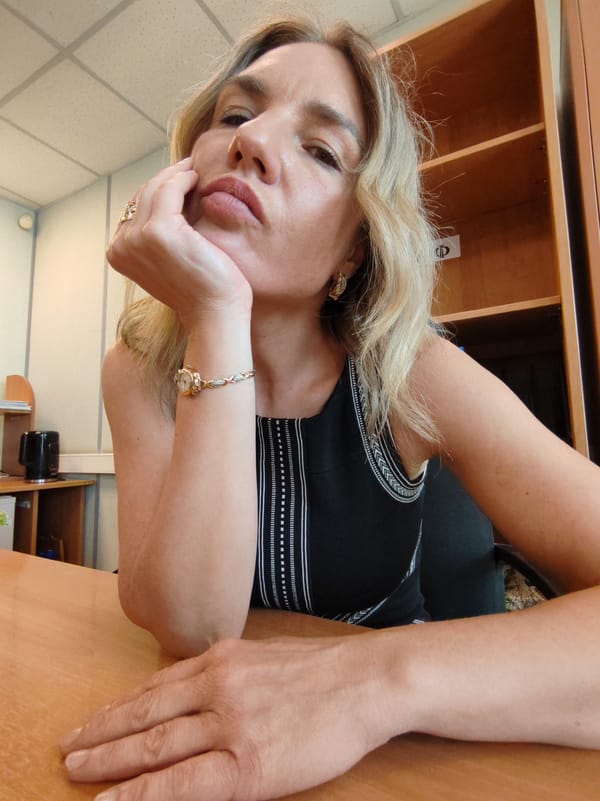 Blonde woman documented working at office desk during morning hours