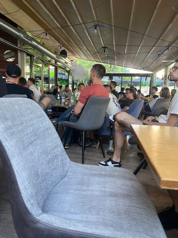 Crowded cafe with glass ceiling captured by witness
