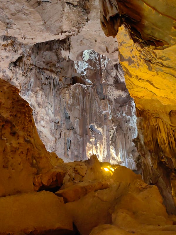 Tourists explore and photograph Tam Thanh Cave in Vietnam