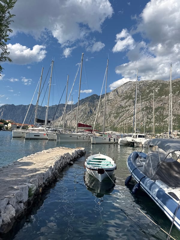 Sailboats moored on a quiet summer afternoon in Prčanj