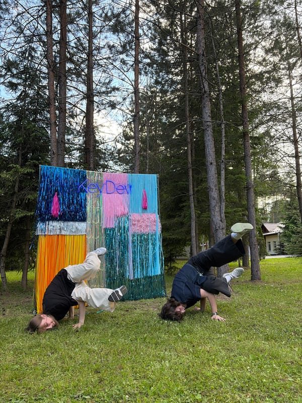 Outdoor KeyDev event with dancing and a tinsel backdrop near Minsk