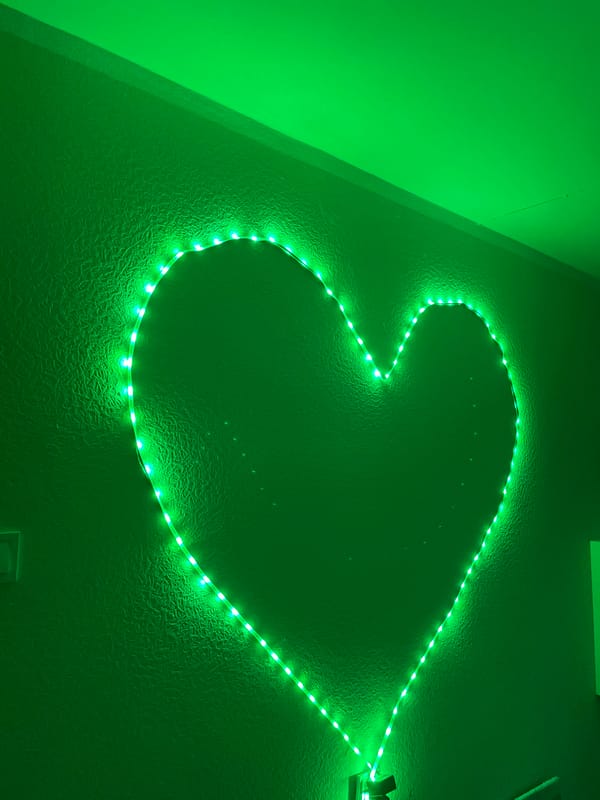 Heart-shaped LED display changes colors on Tallinn wall at dusk