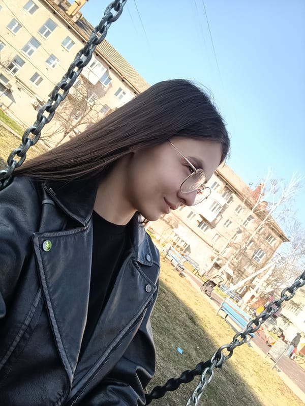 Woman takes selfies on playground swing with bunny backpack