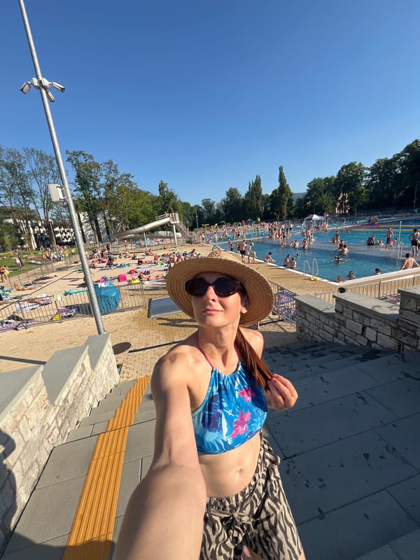 Crowded outdoor pool on a bright summer afternoon
