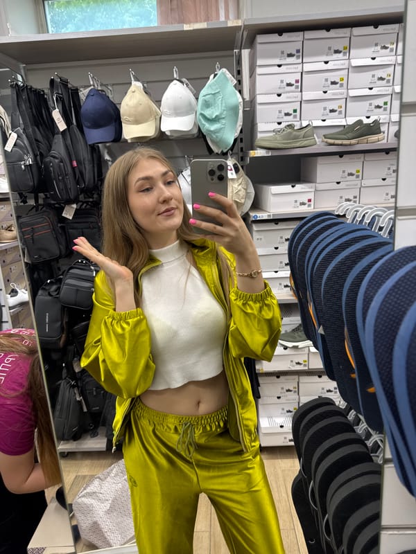 Woman takes mirror selfies in tracksuit at Ussurijsk store