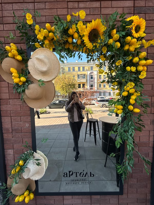Ornate clock and floral displays observed on Krasnoyarsk building