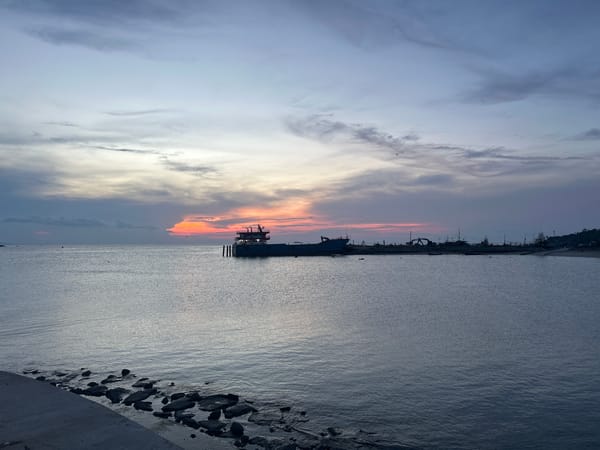 Sunset gathering documented at Thong Sala pier, Thailand