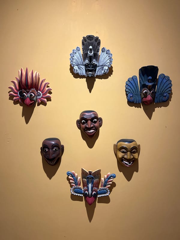 Traditional Sri Lankan masks displayed on wall in Galle
